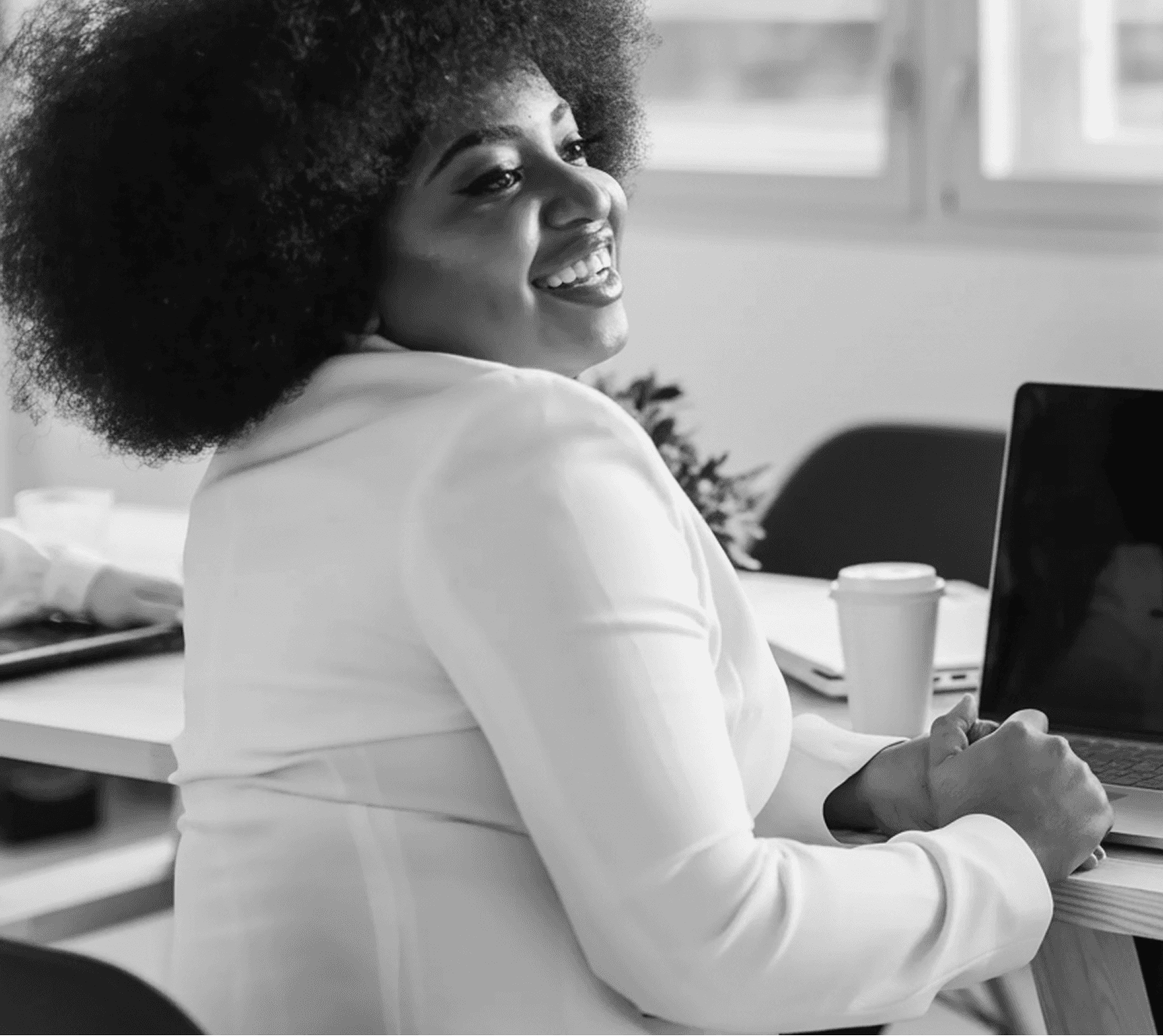 Smart woman smiling with laptop on desk