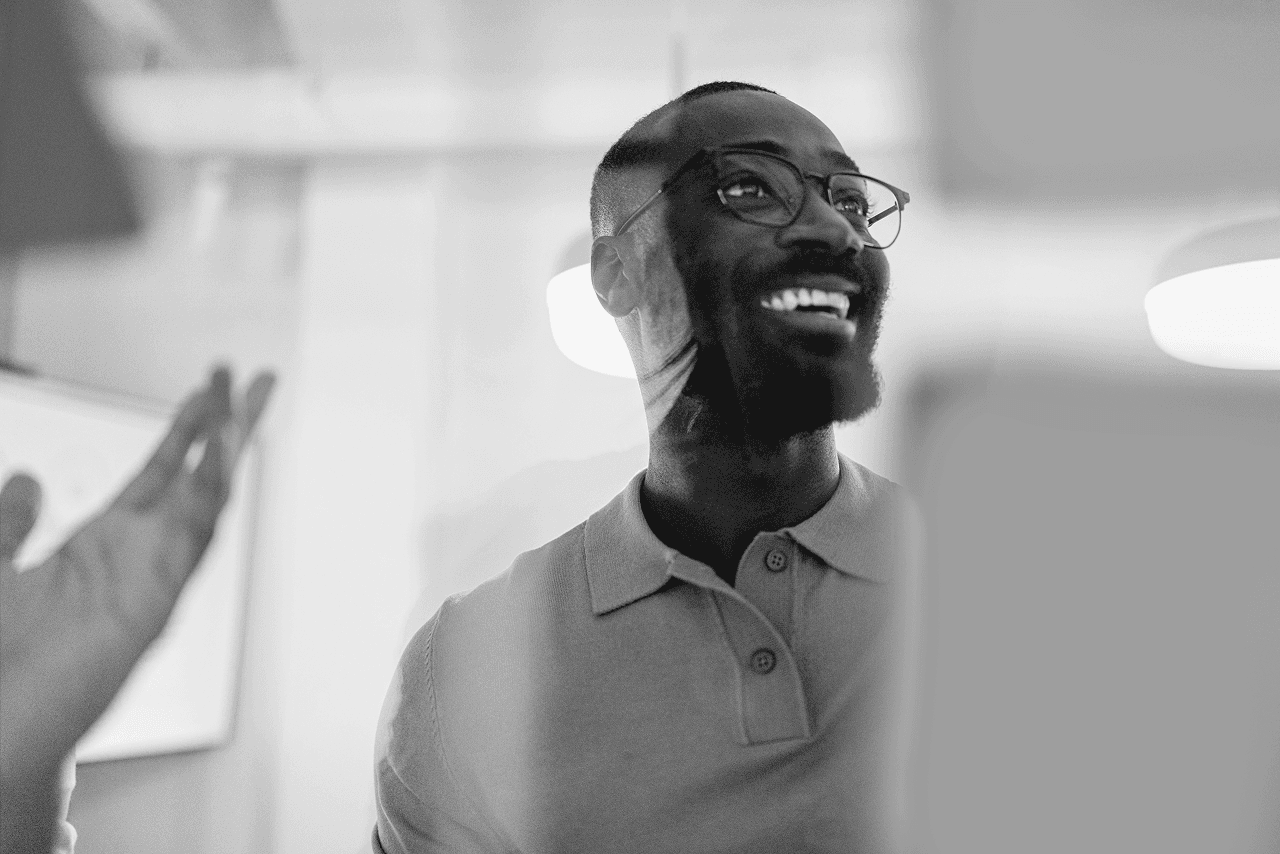 Man smiling with sticky notes in the foreground