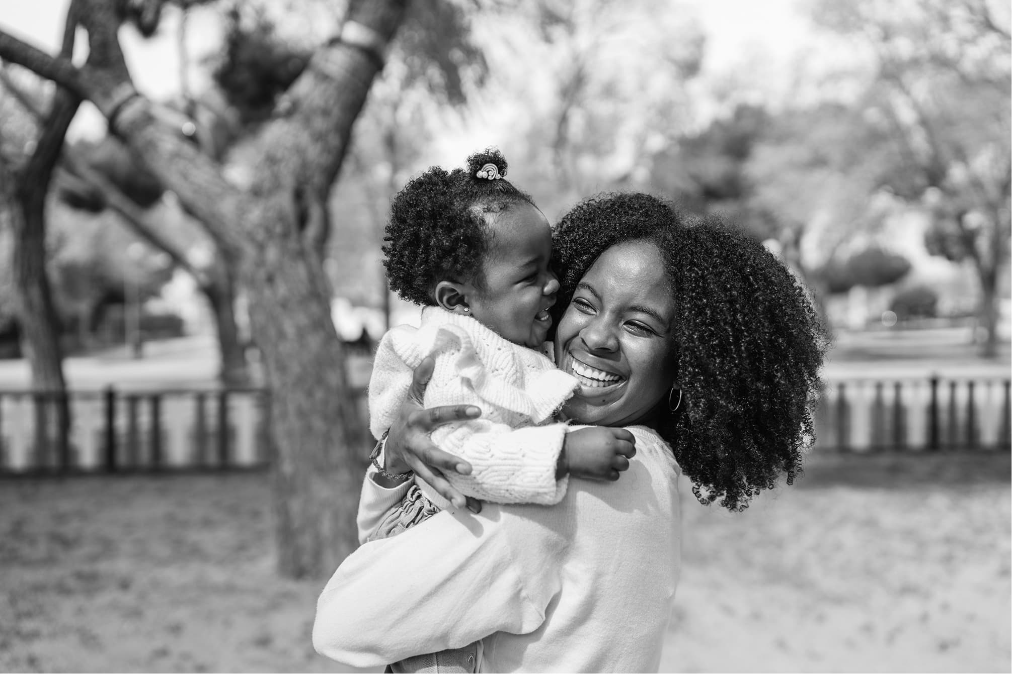 Woman smiling while carrying a child
