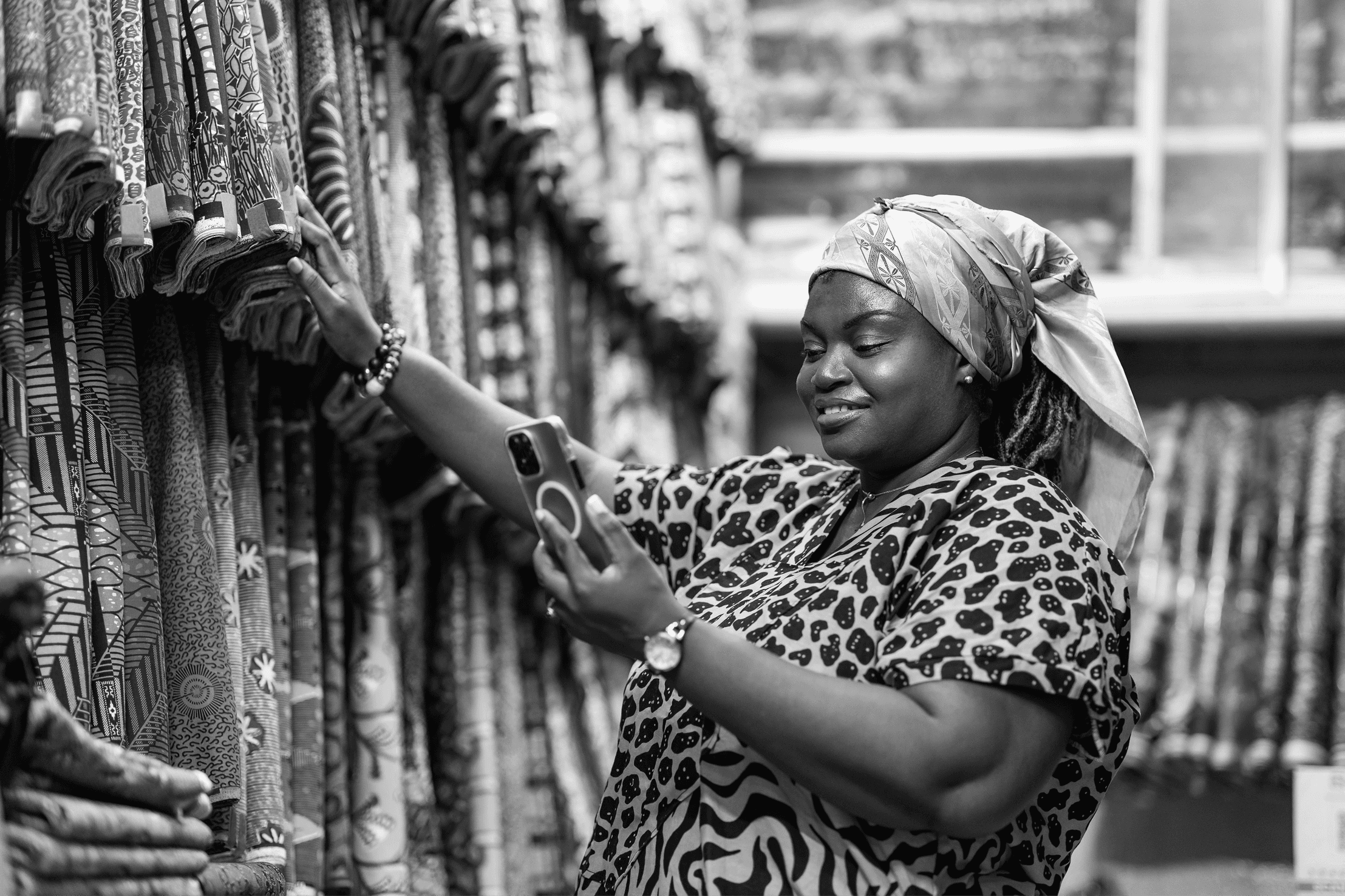 Woman using mobile phone in a textile market