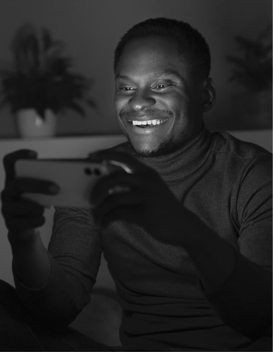 Man smiling watching on smartphone