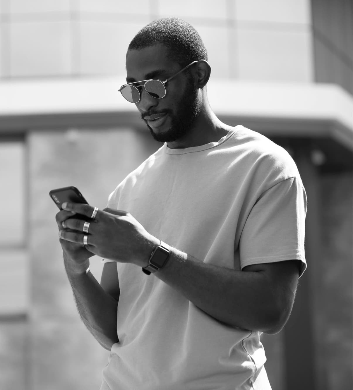 Man wearing glasses holding phone